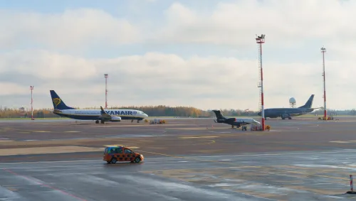 Ryanair and other airplanes parked on the runway of an airport during daytime